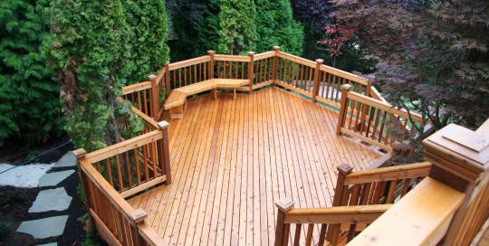 An aerial view of a wooden deck in a backyard.