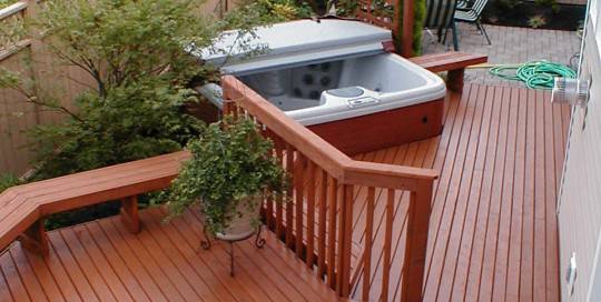 A wooden deck with a hot tub.