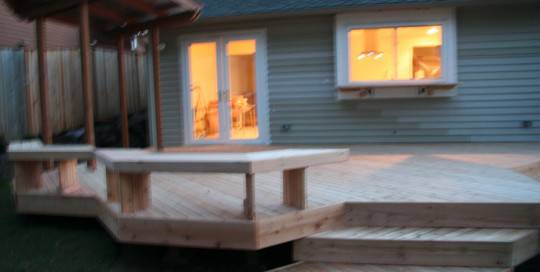 A wooden deck with steps and a bench.