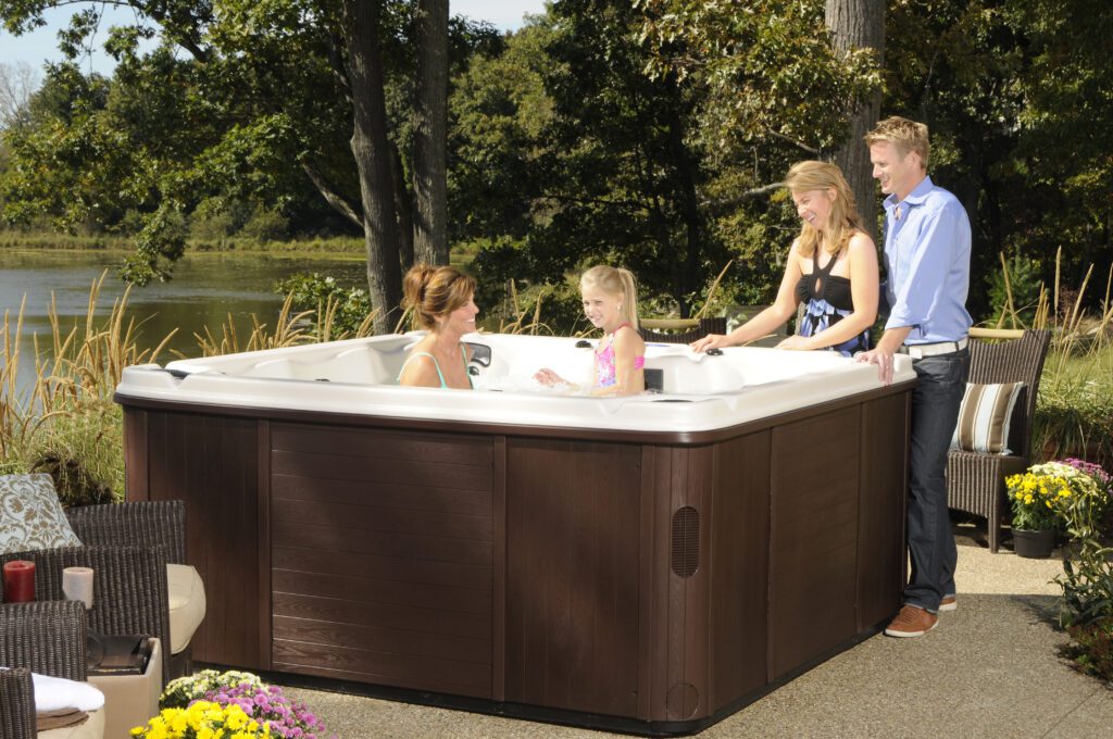 Four people are shown with a hot tub in the image