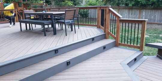 A wooden deck with stairs and a dog on it.