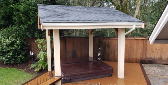A hot tub on top of a wooden deck.