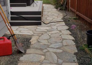 White stone pavers are shown outside a house