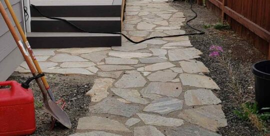 White stone pavers are shown outside a house