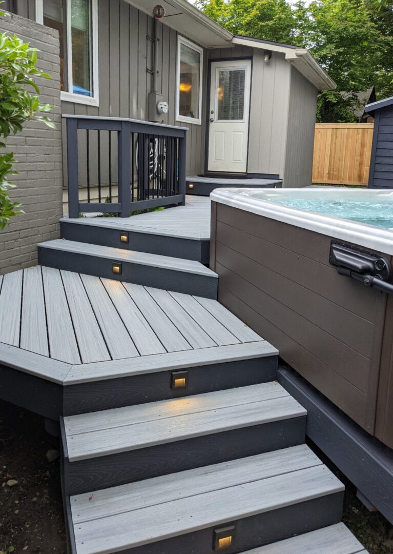 A deck with a hot tub and steps.
